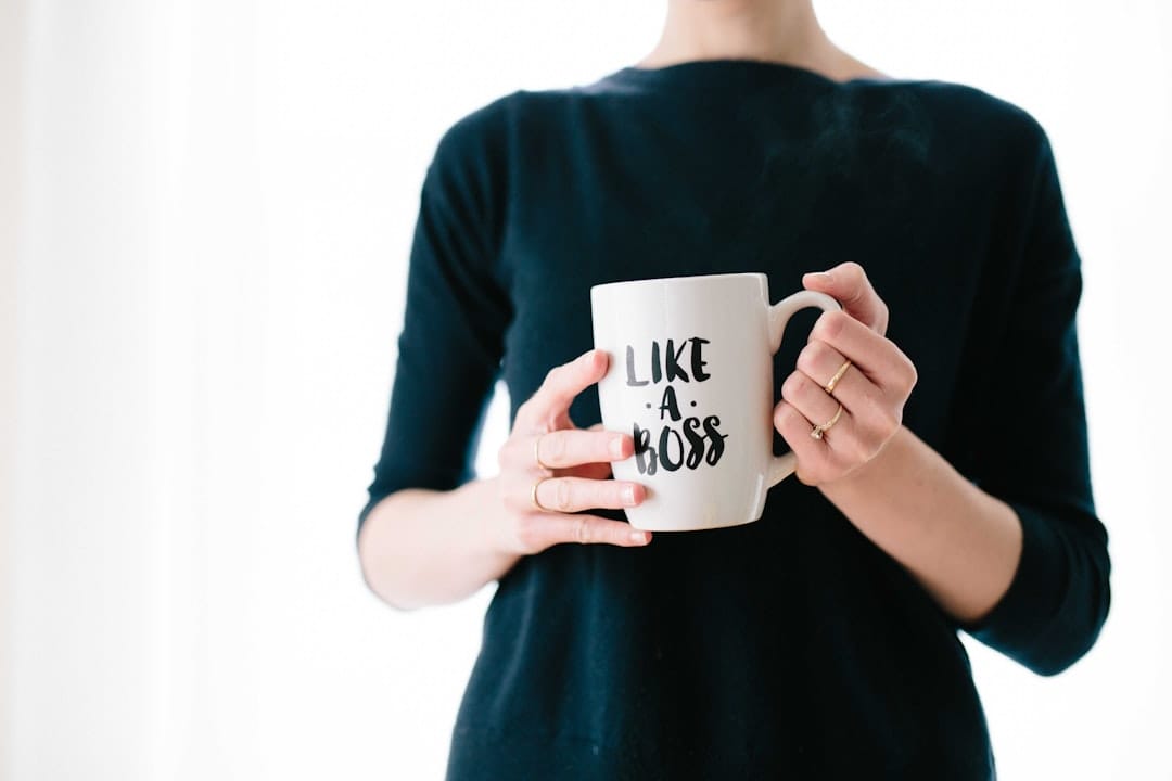 A confident individual holding a mug with the phrase 